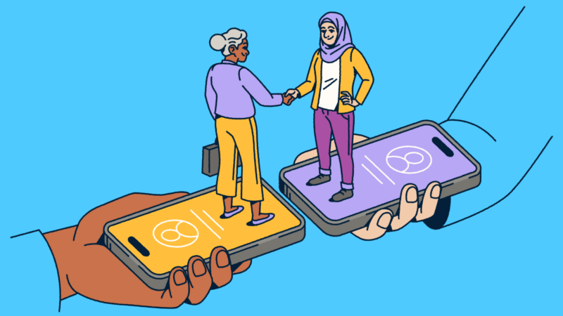 Two people standing on smartphones shaking hands.