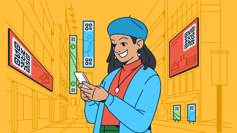 A woman standing in a city with digital advertisements featuring QR Codes around her. She's holding a smartphone in her hands.