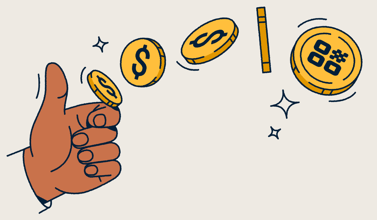 A hand flipping a coin with a QR Code on it.